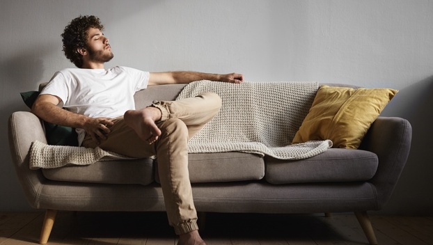 Man Relaxing On Sofa